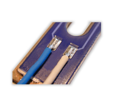 Soldering of single stranded wires on a metallic support with applied printing in thick-film technology. 

Use of a profiled soldering bar for the optimal positioning of the stranded wires to the soldering pads and for an improved heat input compared to a flat soldering bar.

The profiling of the soldering bar is product-specific and, therefore, can be adapted to the respective wire cross section.

There is an open choice of the number of profilings.

Profilings can be of different shapes and sizes. Thus conductors with different cross sections can be soldered in just one process step.